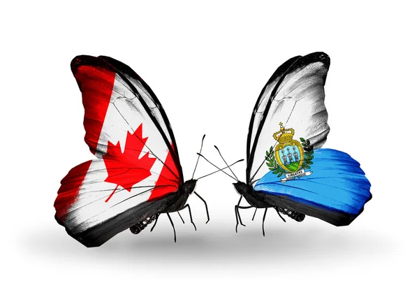 İki kanat bayrakları ile ilişkileri sembolü olarak Kanada ve san marino kelebekler — Stok fotoğraf