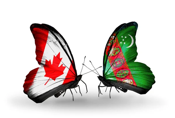 Two butterflies with flags on wings as symbol of relations Canada and Turkmenistan — Stock Photo, Image