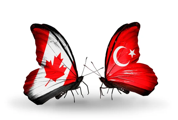 Two butterflies with flags on wings as symbol of relations Canada and Turkey — Stock Photo, Image