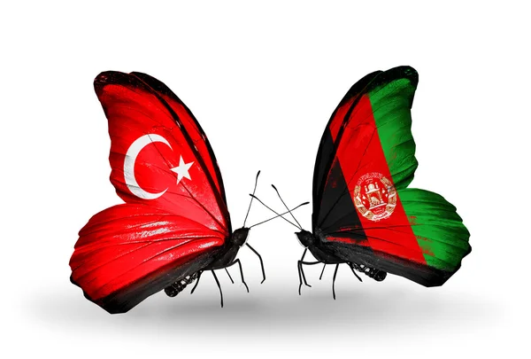 Dos mariposas con banderas en alas como símbolo de relaciones Turquía y Afganistán —  Fotos de Stock