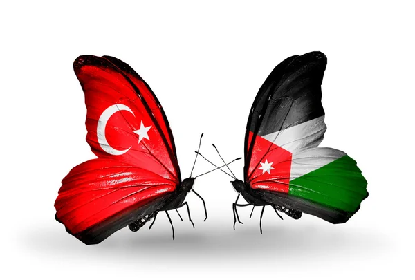 Deux papillons avec des drapeaux sur les ailes comme symbole des relations Turquie et Jordanie — Photo