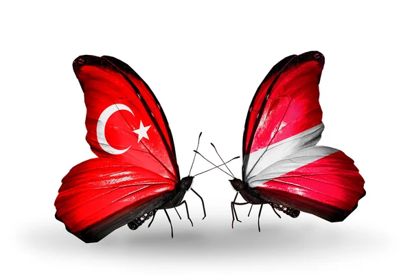 Two butterflies with flags on wings as symbol of relations Turkey and Latvia — Stock Photo, Image