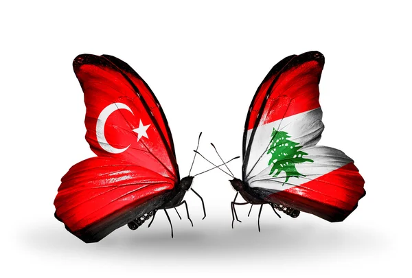Duas borboletas com bandeiras em asas como símbolo das relações Turquia e Líbano — Fotografia de Stock