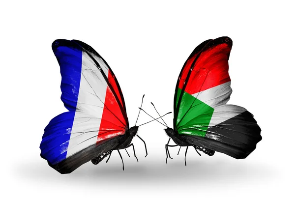 Deux papillons avec des drapeaux sur les ailes comme symbole des relations France et Soudan — Photo