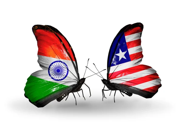 Twee vlinders met vlaggen op vleugels als symbool van de betrekkingen, india en liberia — Stockfoto