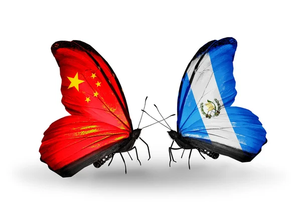 Two butterflies with flags on wings as symbol of relations China and Guatemala — Stock Photo, Image