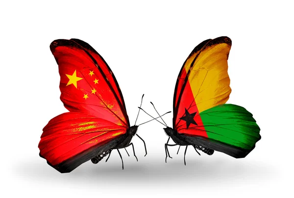 Two butterflies with flags on wings as symbol of relations China and Guinea Bissau — Stock Photo, Image