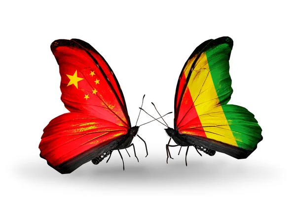 Two butterflies with flags on wings as symbol of relations China and Guinea — Stock Photo, Image