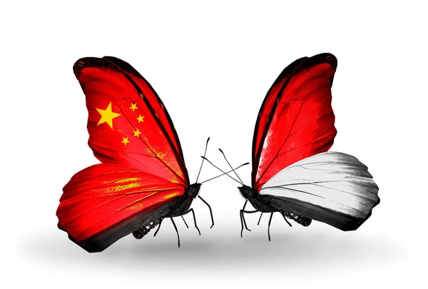 Dva motýli s příznaky na křídlech jako symbol vztahů s Čínou a Monako, Indonésie — Stock fotografie