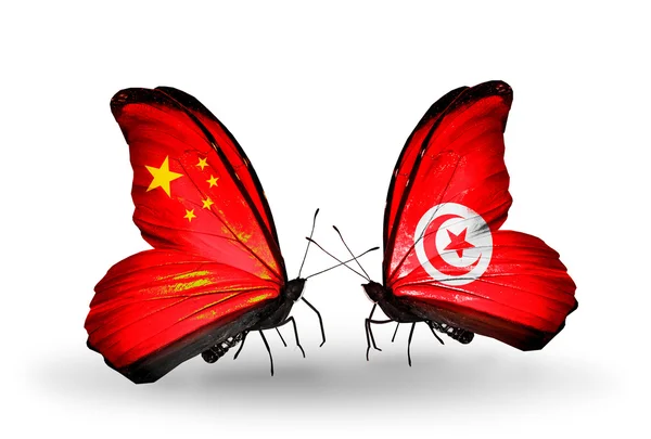 Iki kelebek kanatları ilişkileri Çin ve Tunus sembolü olarak bayrakları ile — Zdjęcie stockowe