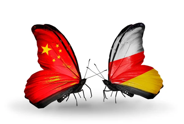 Two butterflies with flags on wings as symbol of relations China and South Ossetia — Stock Photo, Image