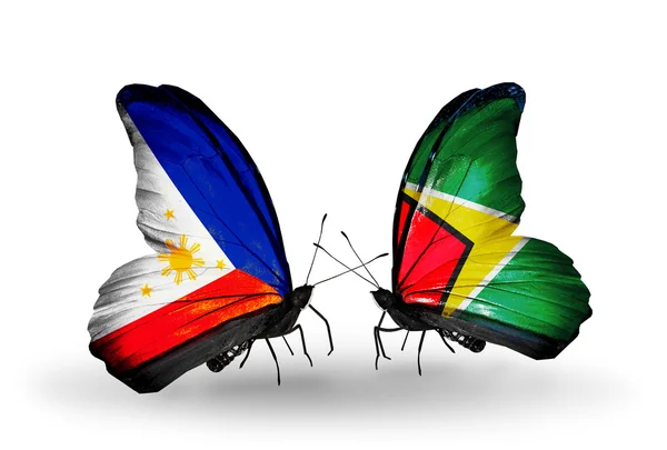 Two butterflies with flags on wings as symbol of relations Philippines and Guyana — Stock Photo, Image