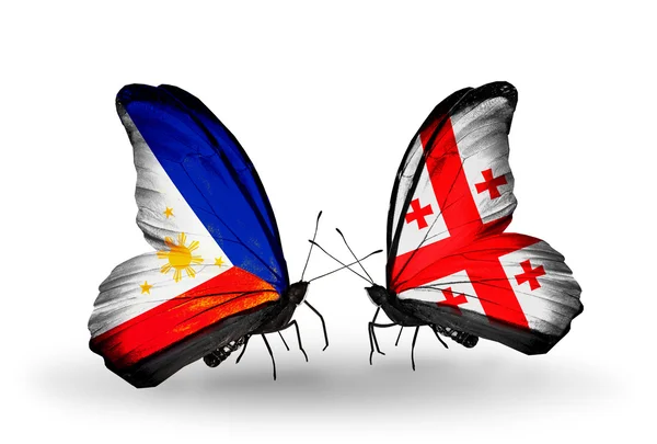 Two butterflies with flags on wings as symbol of relations Philippines and Georgia — Stock Photo, Image