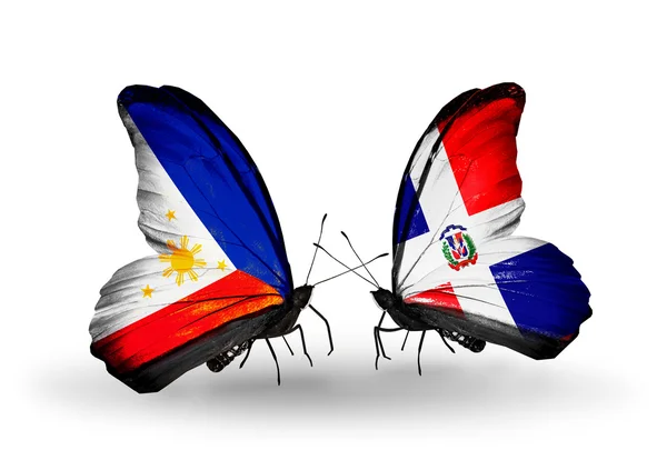 Two butterflies with flags on wings as symbol of relations Philippines and Dominicana — Stock Photo, Image