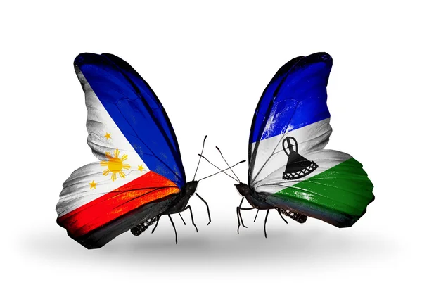 Two butterflies with flags on wings as symbol of relations Philippines and Lesotho — Stock Photo, Image