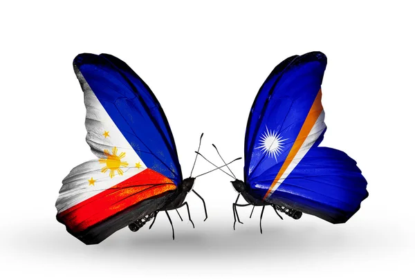 Two butterflies with flags on wings as symbol of relations Philippines and Marshall islands — Stock Photo, Image