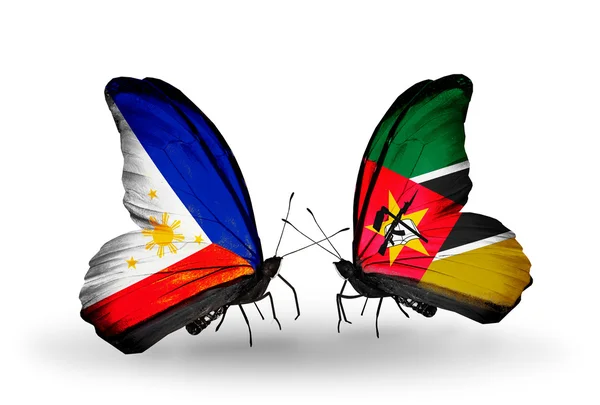 Two butterflies with flags on wings as symbol of relations Philippines and Mozambique — Stock Photo, Image