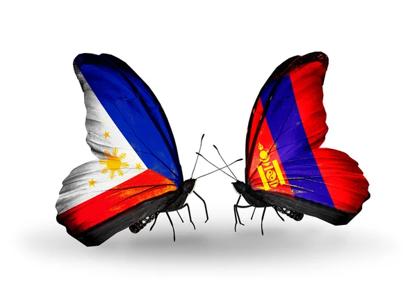 Två fjärilar med flaggor på vingarna som symbol för förbindelserna mellan Filippinerna och Mongoliet — Stockfoto