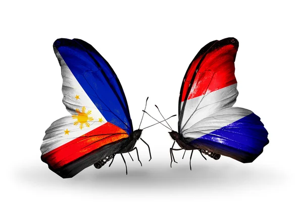 Two butterflies with flags on wings as symbol of relations Philippines and Holland — Stock Photo, Image