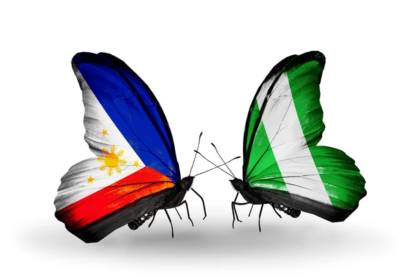 Two butterflies with flags on wings as symbol of relations Philippines and Nigeria — Stock Photo, Image