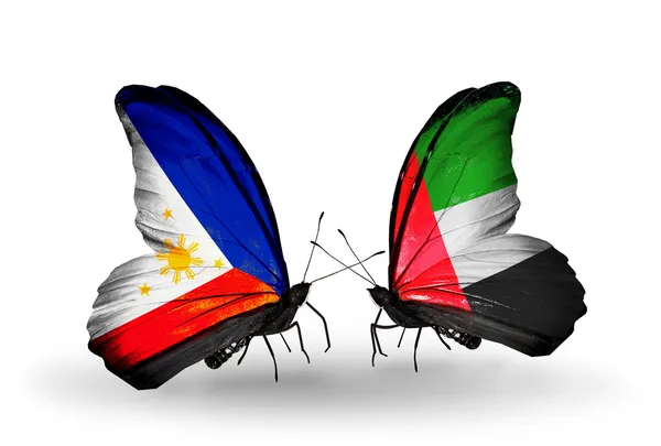 Dwa motyle z flagami na skrzydłach jako symbol stosunków Filipiny i Zjednoczone Emiraty Arabskie — Zdjęcie stockowe