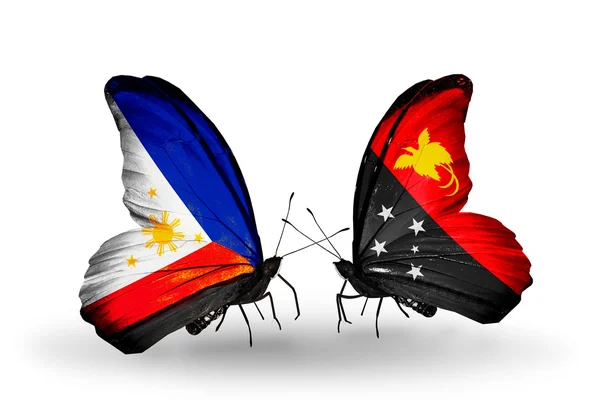 2 つの蝶の翼上のフラグとの関係の記号としてフィリピン、パプア ニューギニア — ストック写真