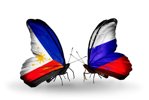 Twee vlinders met vlaggen op vleugels als symbool van de betrekkingen, Filippijnen en Rusland — Stockfoto