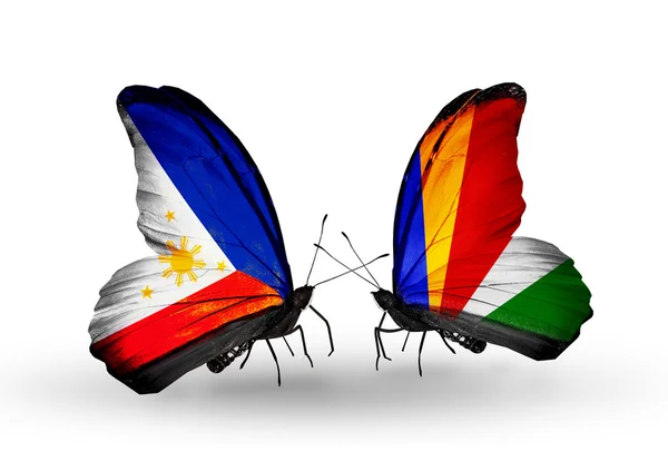 Two butterflies with flags on wings as symbol of relations Philippines and Seychelles — Stock Photo, Image