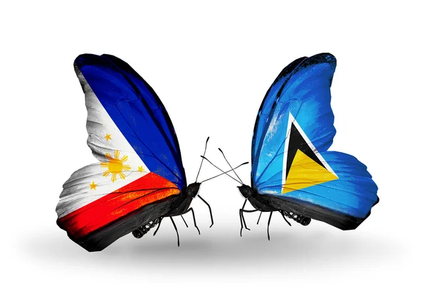 Dwa motyle z flagami na skrzydłach jako symbol stosunków, Filipiny i saint lucia — Zdjęcie stockowe