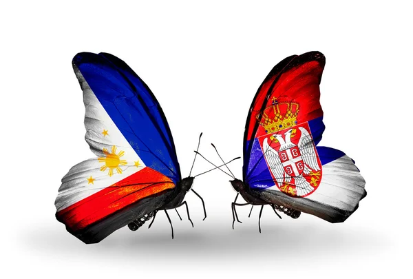 Dwa motyle z flagami na skrzydłach jako symbol stosunków, Filipiny i Serbii — Zdjęcie stockowe