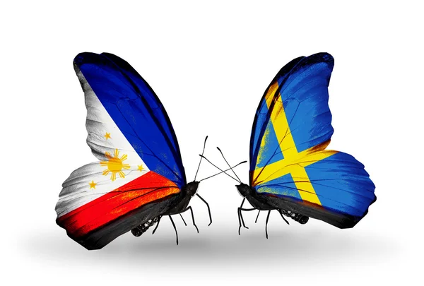 Two butterflies with flags on wings as symbol of relations Philippines and Sweden — Stock Photo, Image