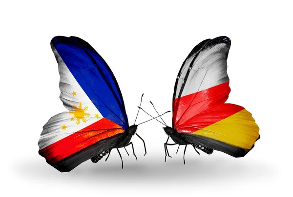 Two butterflies with flags on wings as symbol of relations Philippines and South Ossetia — Stock Photo, Image