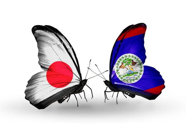 Duas borboletas com bandeiras em asas como símbolo de relações Japão e Belize — Fotografia de Stock