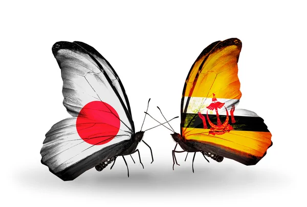 Twee vlinders met vlaggen op vleugels als symbool van betrekkingen japan en brunei — Stockfoto