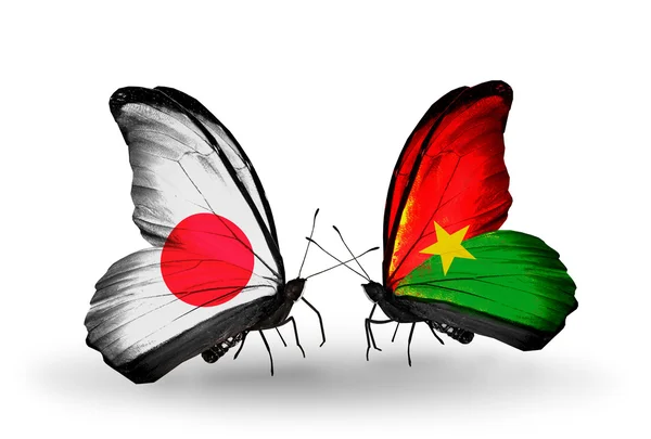 Twee vlinders met vlaggen op vleugels als symbool van betrekkingen japan en burkina faso — Stockfoto