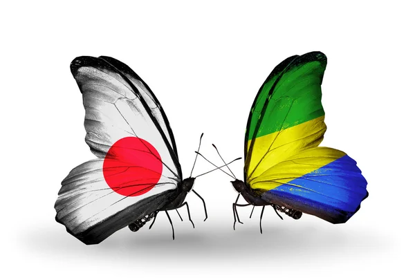 Two butterflies with flags on wings as symbol of relations Japan and Gabon — Stock Photo, Image