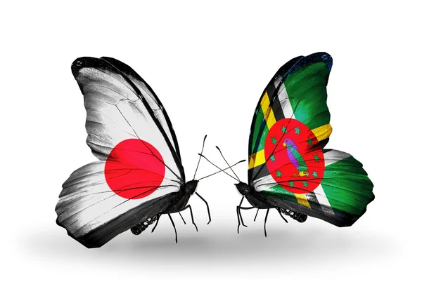 Twee vlinders met vlaggen op vleugels als symbool van betrekkingen japan en dominica — Stockfoto
