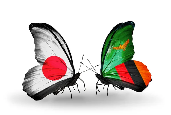 Dos mariposas con banderas en alas como símbolo de relaciones Japón y Zambia — Foto de Stock