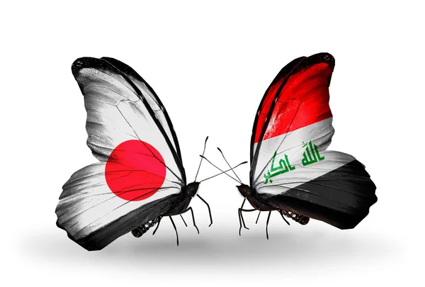 Två fjärilar med flaggor på vingarna som symbol för förbindelserna mellan japan och Irak — Stockfoto