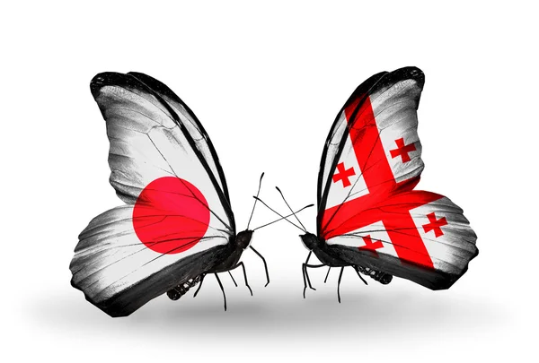 Dos mariposas con banderas en alas como símbolo de relaciones Japón y Georgia —  Fotos de Stock