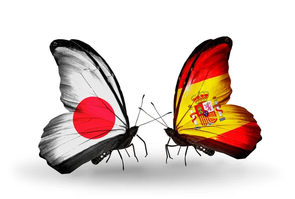 Dua kupu-kupu dengan bendera di sayap sebagai simbol hubungan Jepang dan Spanyol — Stok Foto