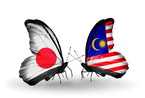 Two butterflies with flags on wings as symbol of relations Japan and Malaysia — Stock Photo, Image