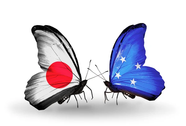 Two butterflies with flags on wings as symbol of relations Japan and Micronesia — Stock Photo, Image