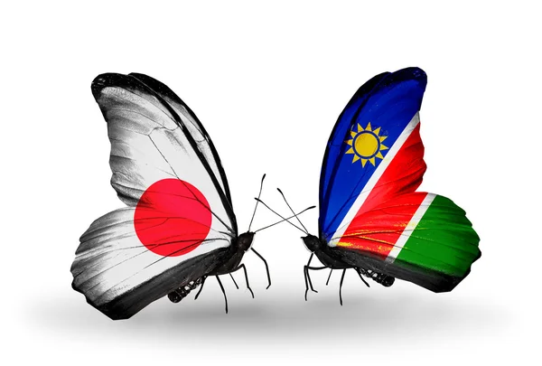 Due farfalle con bandiere sulle ali come simbolo delle relazioni Giappone e Namibia — Foto Stock