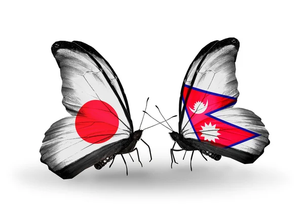 Dos mariposas con banderas en alas como símbolo de relaciones Japón y Nepal — Foto de Stock