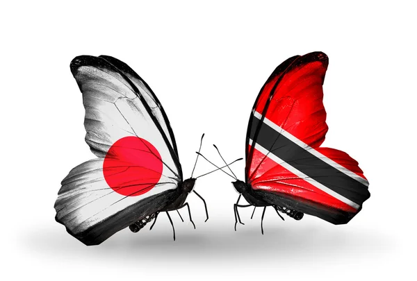 Dos mariposas con banderas en alas como símbolo de relaciones Japón y Trinidad y Tobago —  Fotos de Stock