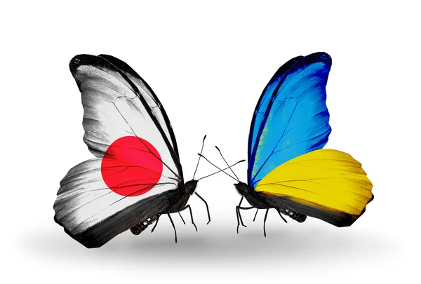 Two butterflies with flags on wings as symbol of relations Japan and Ukraine — Stock Photo, Image