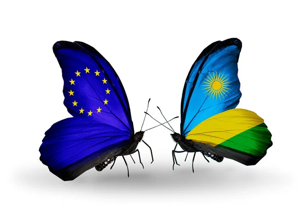 两只蝴蝶带有标志的符号关系欧盟和卢旺达的翅膀 — 图库照片