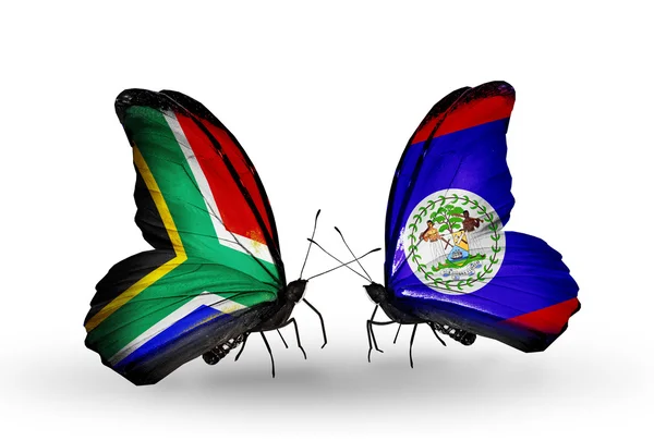 Dos mariposas con banderas en alas como símbolo de las relaciones Sudáfrica y Belice — Foto de Stock