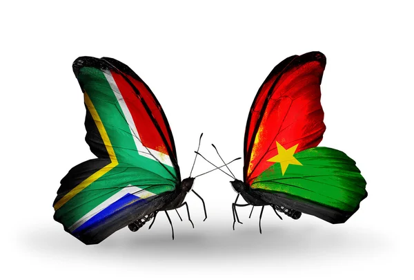 Dwa motyle z flagami na skrzydłach jako symbol stosunków, RPA i burkina faso — Zdjęcie stockowe